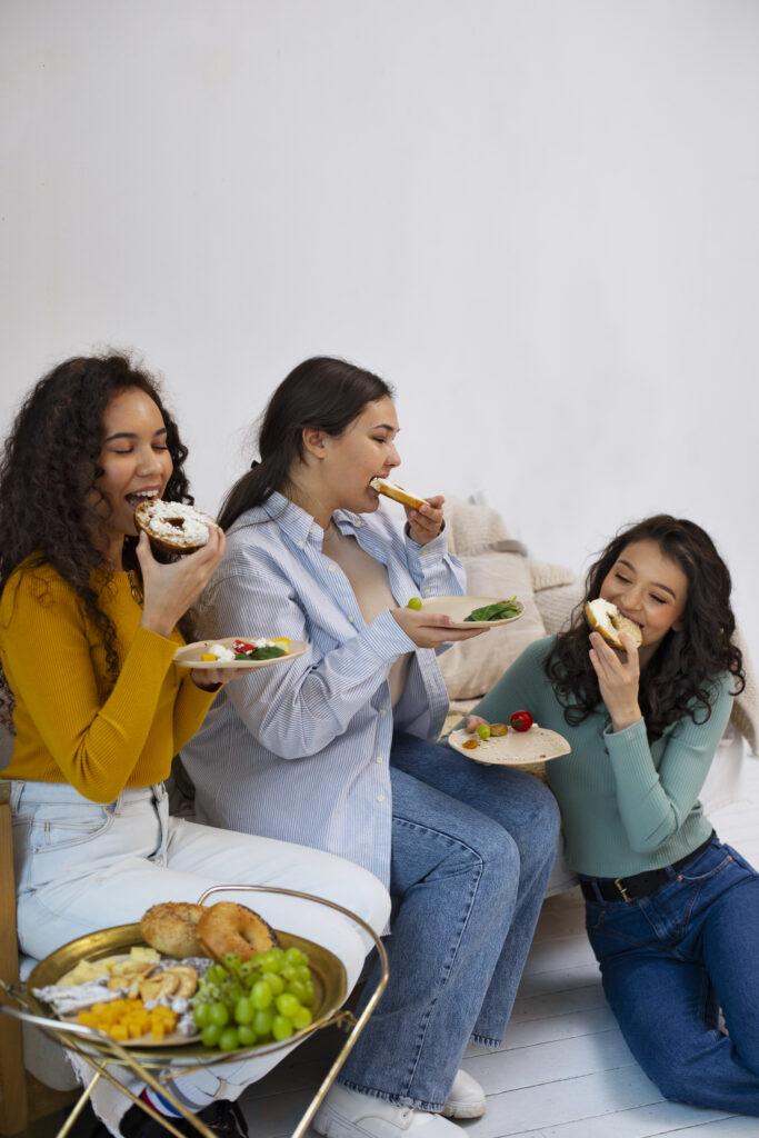 full-shot-women-enjoying-delicious-food
