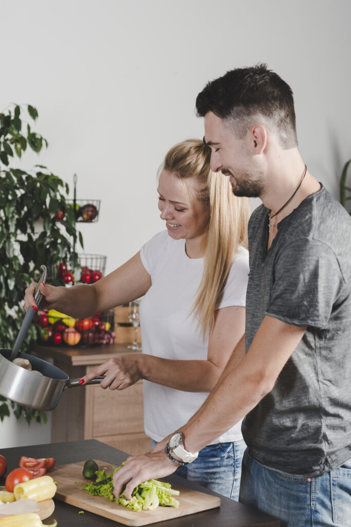 happy-young-couple-preparing-food-kitchen