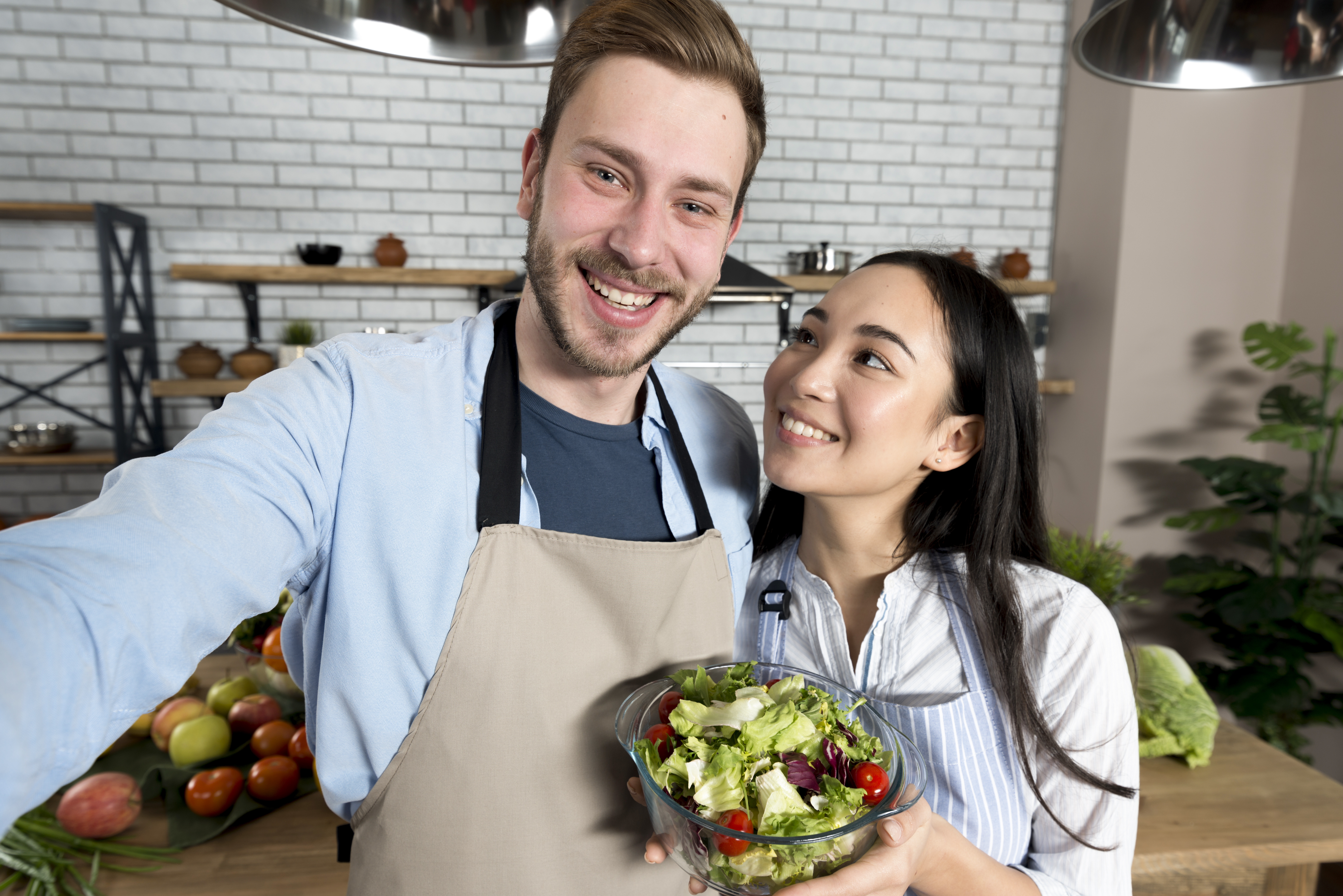 smiling-wife-looking-her-husband-holding-healthy-salad